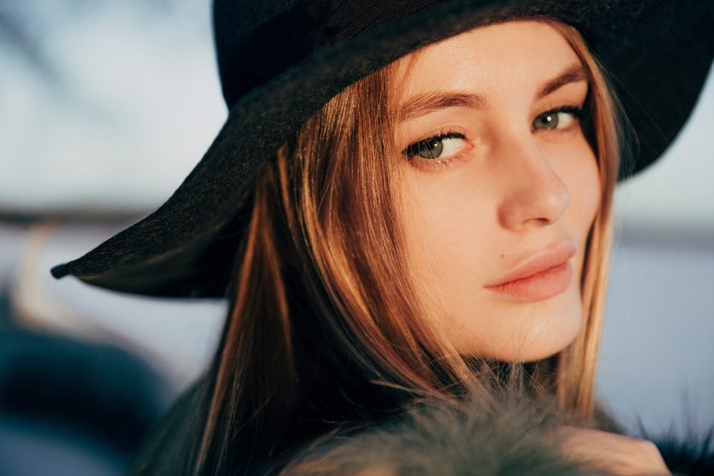 Woman with long hair in black hat.