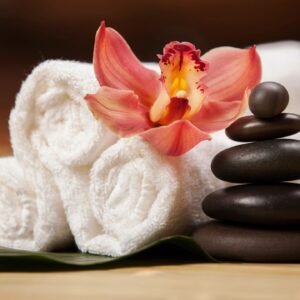 Spa stones and orchid on towels.