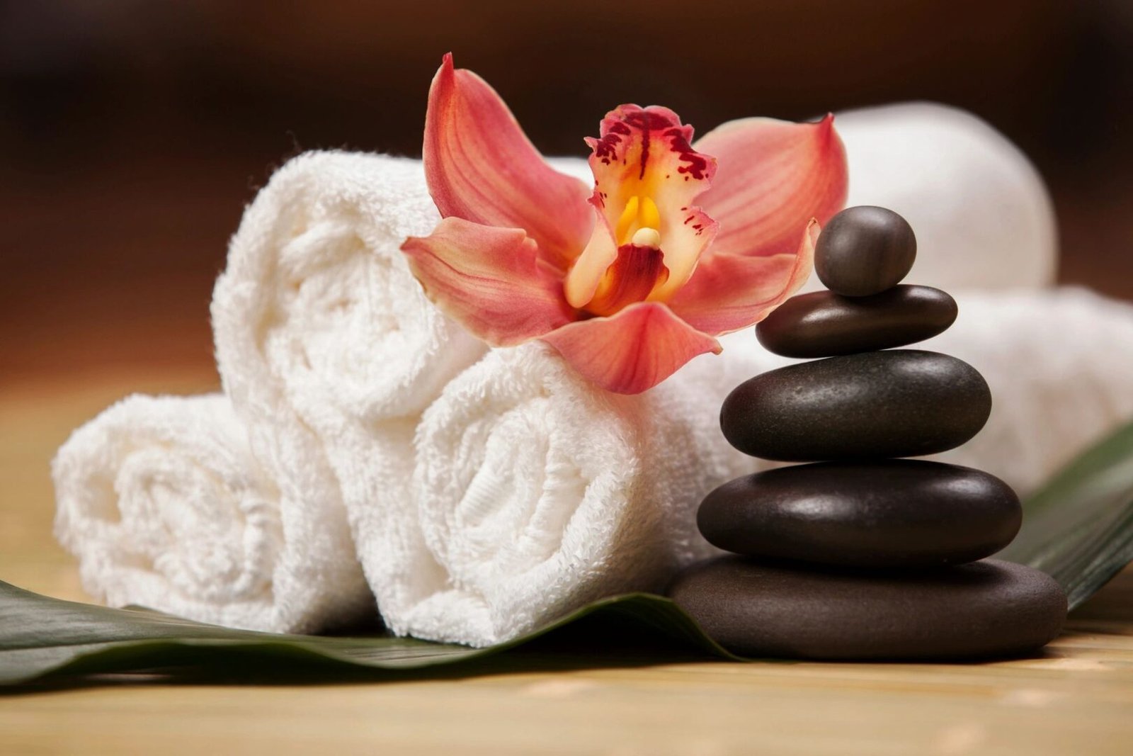Spa stones and orchid on towels.