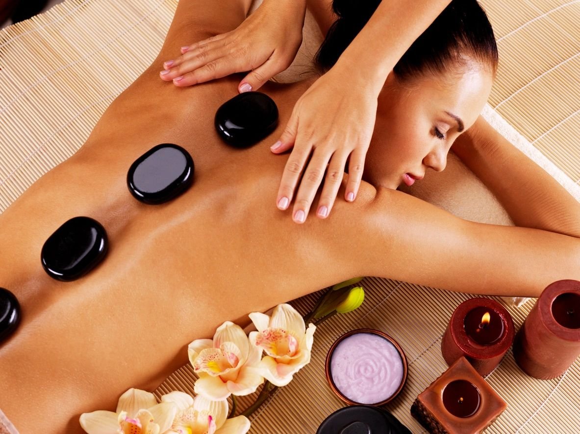 Woman receiving hot stone massage.