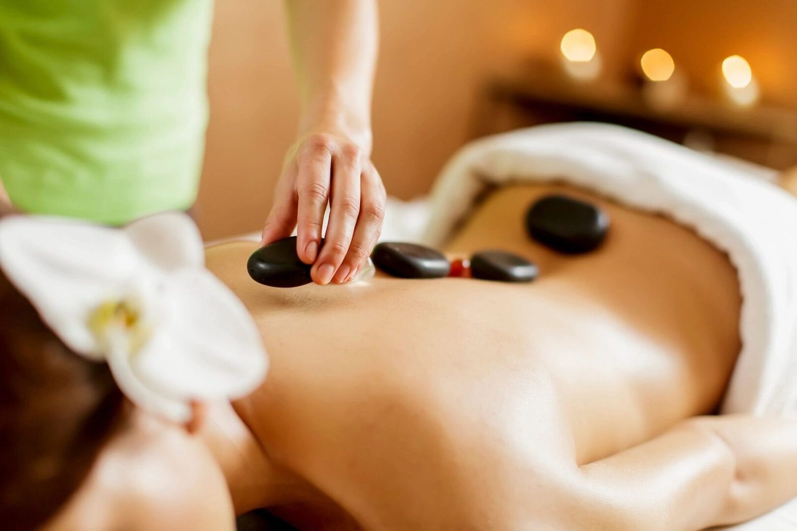 Woman receiving hot stone massage.