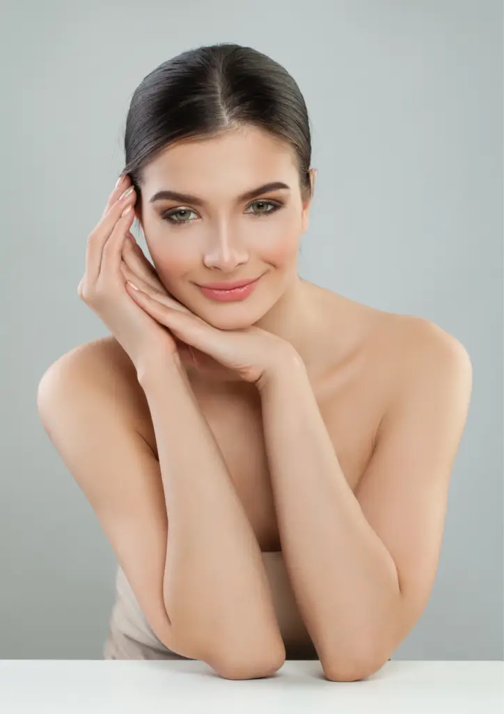 Woman with clear skin and neutral expression.